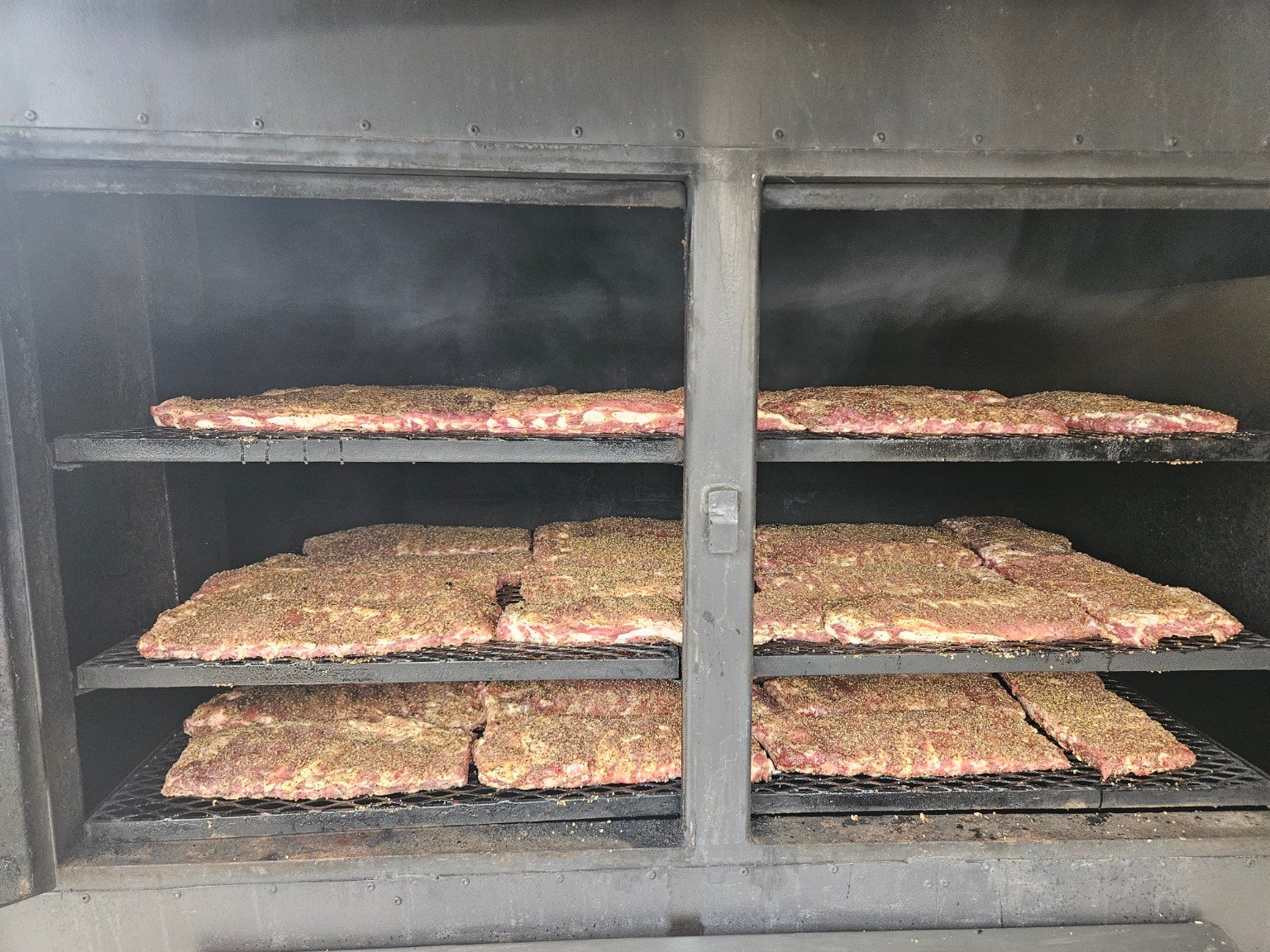 Ribs placed on smoker at Skatts BBQ