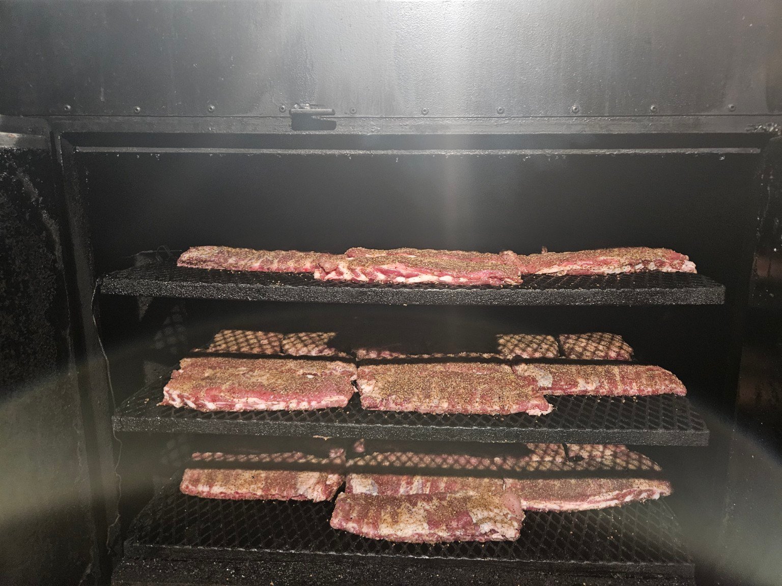 Seasoned ribs ready for slow smoking