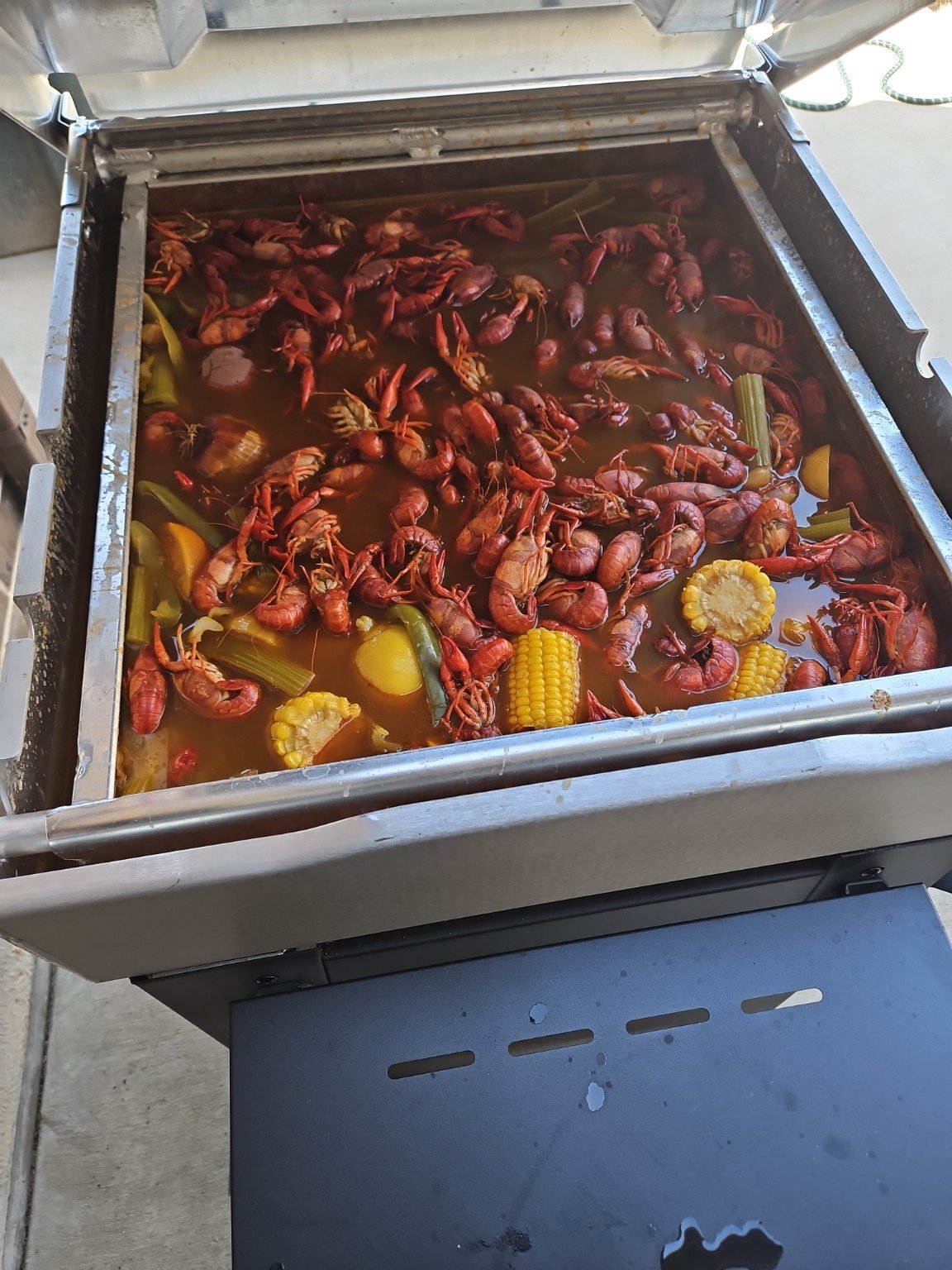 Crawfish boiling with corn potatoes and Cajun seasoning
